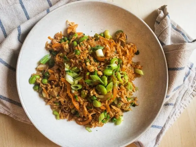 Salmon Fried Rice - A delicious healthy dinner recipe packed with veggies, salmon and egg. Better than a takeaway and the perfect way to use up leftover rice and frozen vegetables.