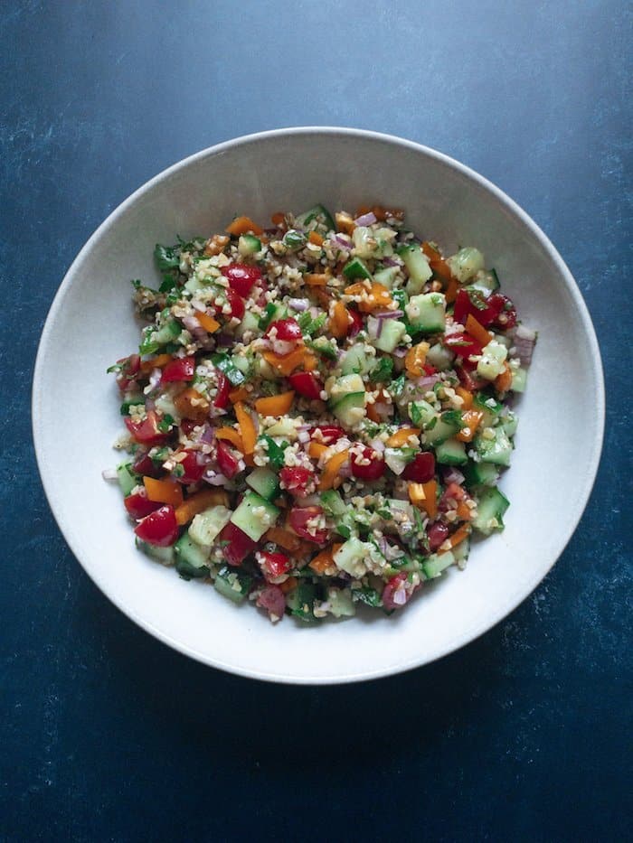 Tabbouleh Style Bulgar Salad - A Lebanese inspired Tabbouleh Salad with Bulgar wheat, peppers, tomatoes and cucumbers with a fresh citrus and sumac dressing. Easy to prepare and keeps well in the fridge for the perfect quick dinner. A great no-cook dish which can be easily made ahead!