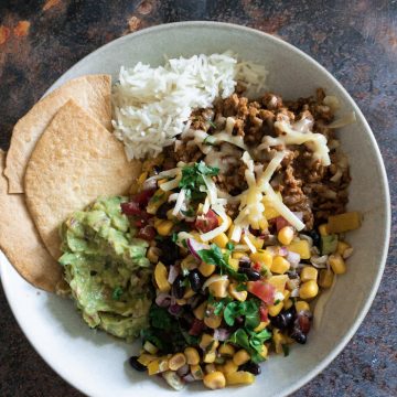 Beef Burrito Bowls with Corn & Black Bean Salsa - All the deliciousness of a classic beef burrito, but lightened up with a fresh and zingy corn and black bean salsa. A great weeknight meal with minimal cooking. Makes excellent leftovers too!