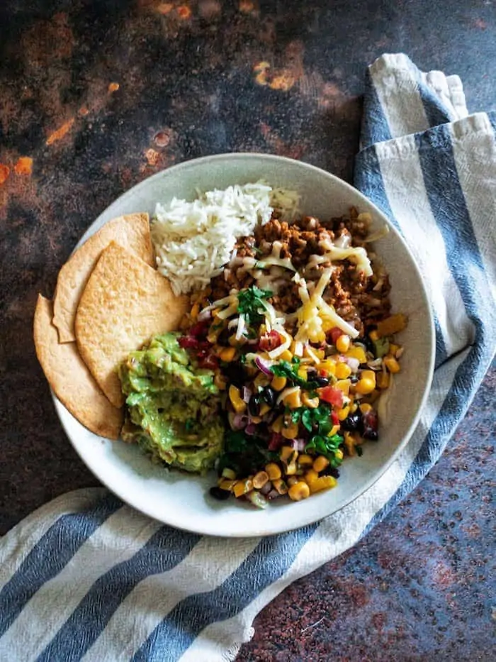 Beef Burrito Bowls with Corn & Black Bean Salsa - All the deliciousness of a classic beef burrito, but lightened up with a fresh and zingy corn and black bean salsa. A great weeknight meal with minimal cooking. Makes excellent leftovers too!