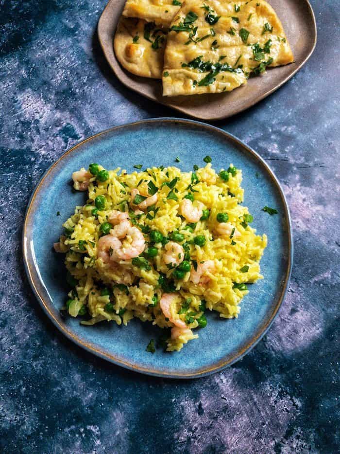 Prawn & Cardamom Rice with Peas - A comforting and mildly spiced dinner of rice baked with cardamom, turmeric and chicken stock with prawns and peas. Easily comes together with some freezer and pantry staples.