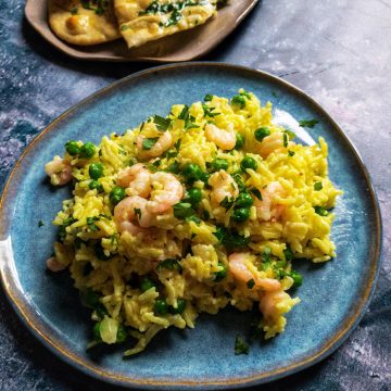 Prawn & Cardamom Rice with Peas - A comforting and mildly spiced dinner of rice baked with cardamom, turmeric and chicken stock with prawns and peas. Easily comes together with some freezer and pantry staples.