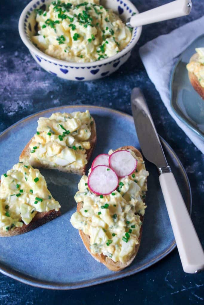 egg mayonnaise on a slice of sourdough toast, garnished with sliced radish