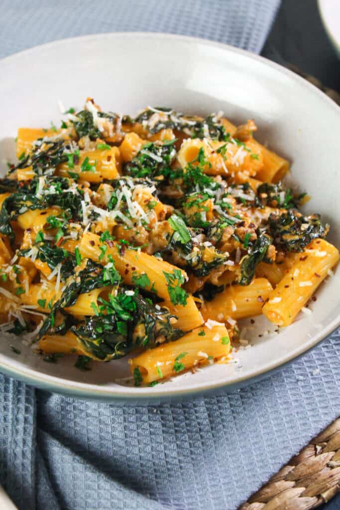 Rigatoni pasta with sausage and cavolo nero, ganished with parsley, chilli flakes and parmesan.