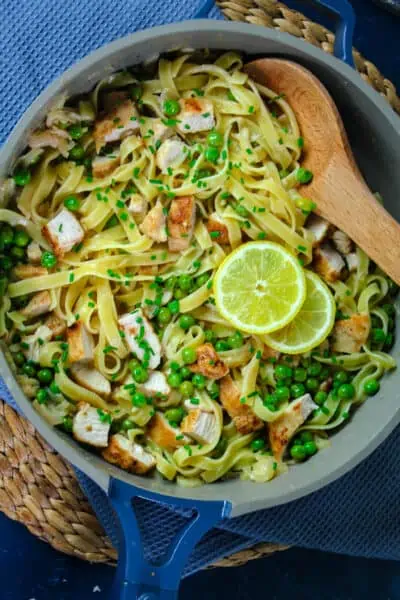 Tagliatelle pasta in a creamy lemon sauce with peas and pan fried chicken breast.