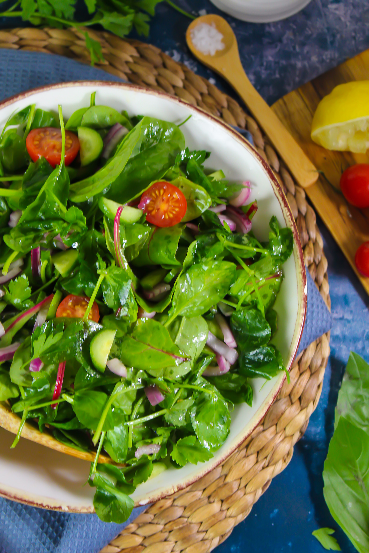 Mixed green salad in a large white salad bowl.