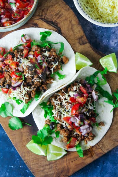 Minced Beef and Black Bean Tacos with salsa and shredded lettuce.