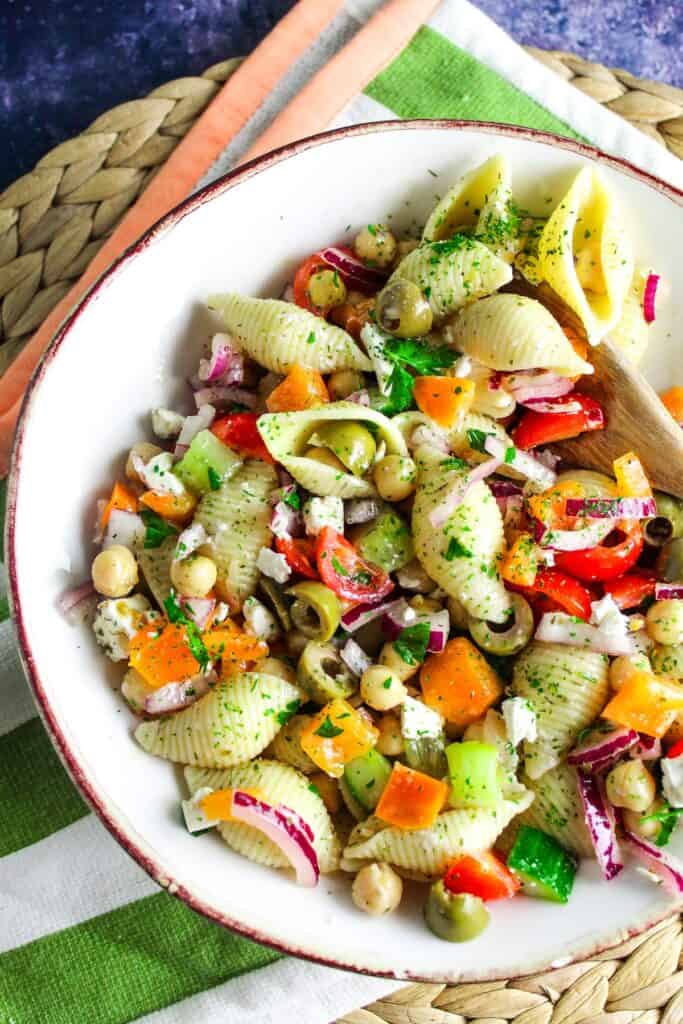 Pasta salad with cucumbers, peppers, and olives.