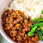 Beef and vegetable stir-fry with rice in a white bowl, colorful healthy home-cooked meal.
