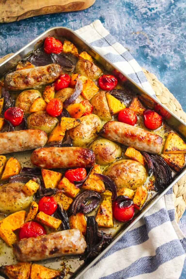 Roasted sausage and vegetable tray bake with cherry tomatoes, potatoes, and seasonal squash.