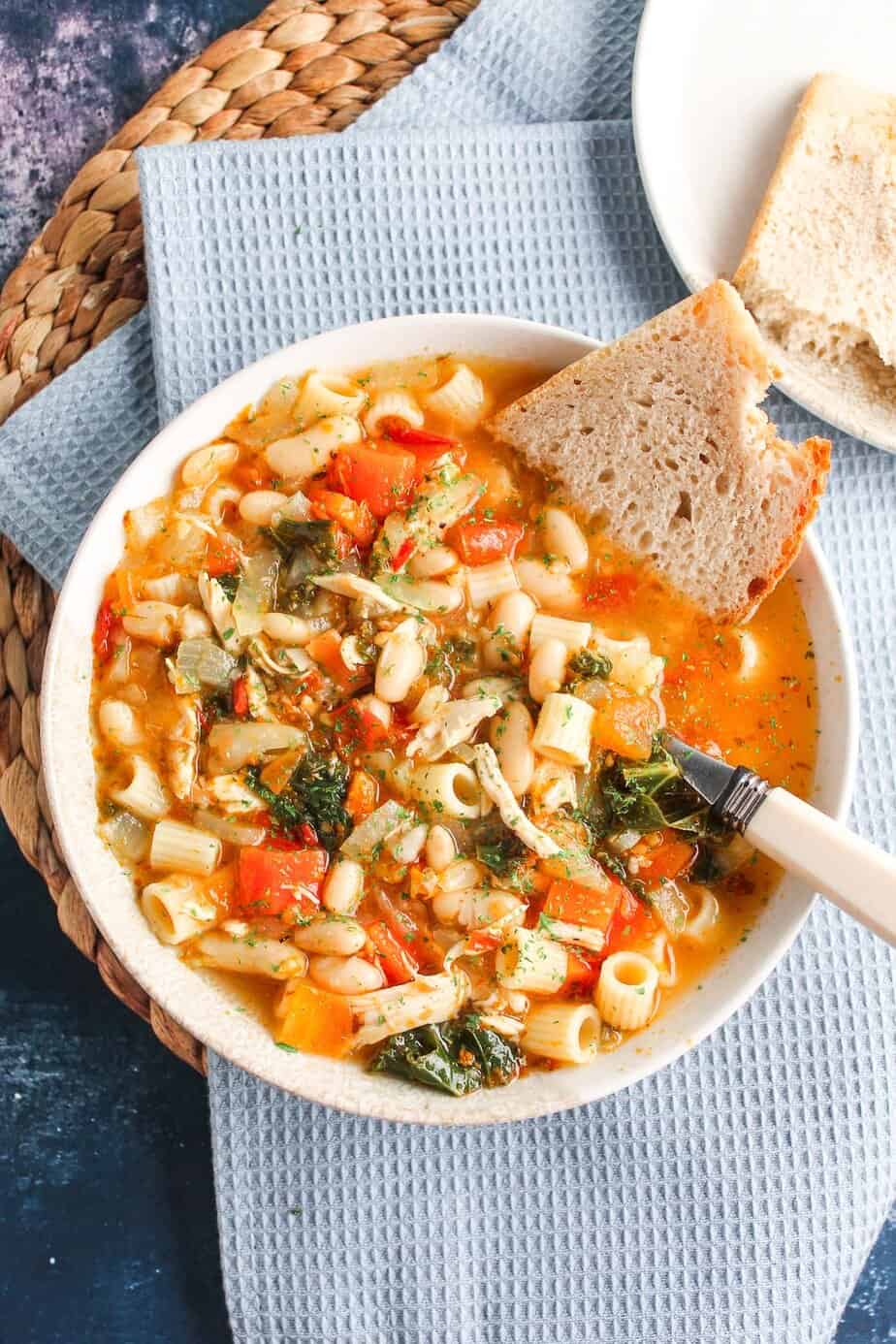 Chicken soup with white beans, pasta and vegetables.