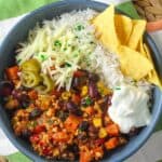 Delicious and hearty chili topped with cheese, sour cream, and served with crunchy tortilla chips.