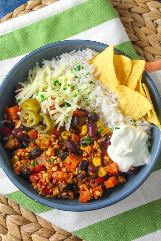 Delicious and hearty chili topped with cheese, sour cream, and served with crunchy tortilla chips.