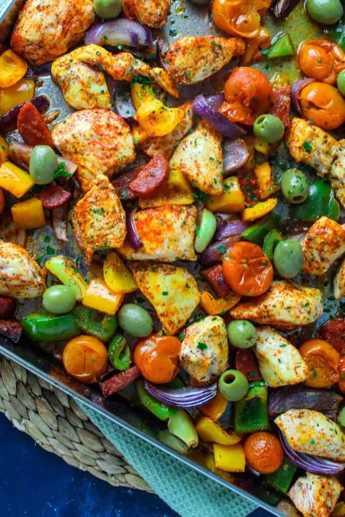 Tray baked chicken breast, chorizo, peppers, olives and cherry tomato with paprika and oregano