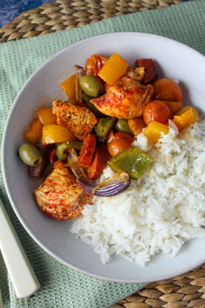 Spanish chicken traybake served with white rice.